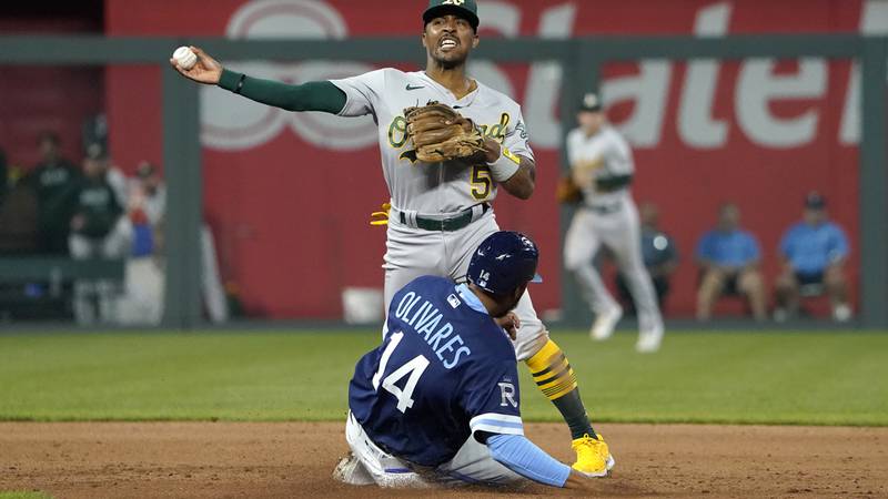 Oakland Athletics second baseman Tony Kemp (5) throws to first base over Kansas City Royals'...