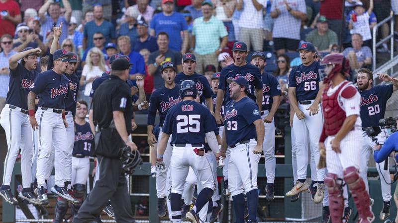 Mississippi infielder Tim Elko (25) celebrates his home run with teammates in the third inning...